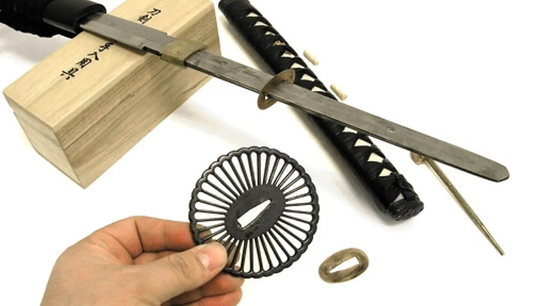 Step-by-step katana disassembly showing the blade, tsuka, tsuba, seppa and bamboo mekugi pins removed from a traditional Japanese sword for maintenance and cleaning.