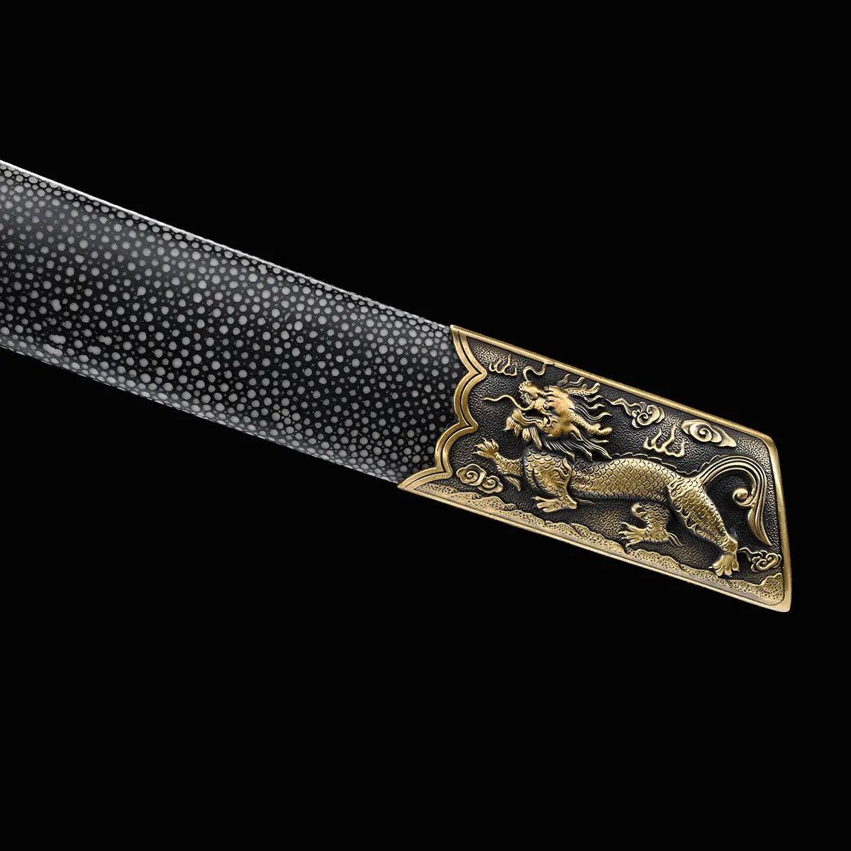 Gros plan sur l’extrémité du fourreau du sabre chinois Dao BAI LONG sur fond noir, avec revêtement sombre texturé, garniture en laiton doré et motif dragon en relief.