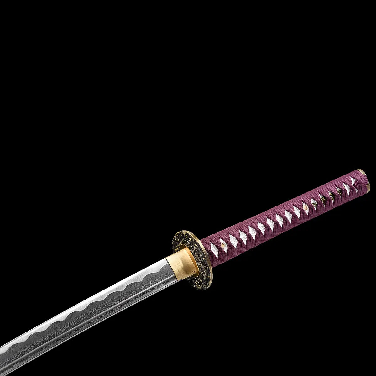 Close-up view of the handcrafted Japanese katana Dokuryu on a black background, showing the purple tsuka wrapped in traditional braid with white ray skin panels exposed, brass habaki fitted at the base of the blade, round metal tsuba engraved with a Japanese dragon, folded steel blade partially visible with a wavy hamon pattern, minimalist studio composition with no scabbard and no stand.
