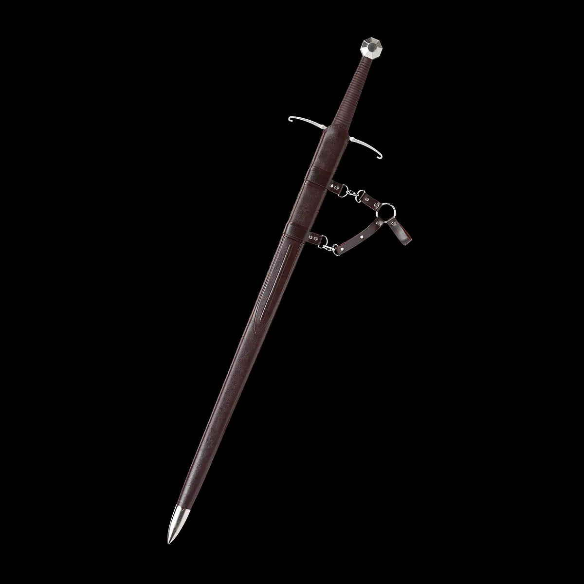 Épée longue médiévale Castelar entièrement rangée dans son fourreau en bois gainé de simili cuir brun, présentée en angle diagonal sur fond noir uniforme. Poignée brun foncé avec pommeau évasé en acier poli, quillons en croix argentés légèrement courbés, attaches et lanières métalliques détaillées. Image haute définition idéale pour les mots-clés épée longue médiévale, longsword main-et-demi, fourreau cuir brun.