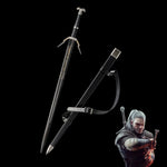 Geralt long sword replica displayed on a deep black background, blade unsheathed next to its black scabbard with leather belt strap attached. The sword features a straight double-edged steel blade with a central fuller and gold engraved inscription near the spine. The crossguard is angular and silver with extended quillons, the grip is wrapped in black textured leather, and the pommel is silver with a wolf head detail. The scabbard is matte black with a metal chape and locket in silver tone.  
