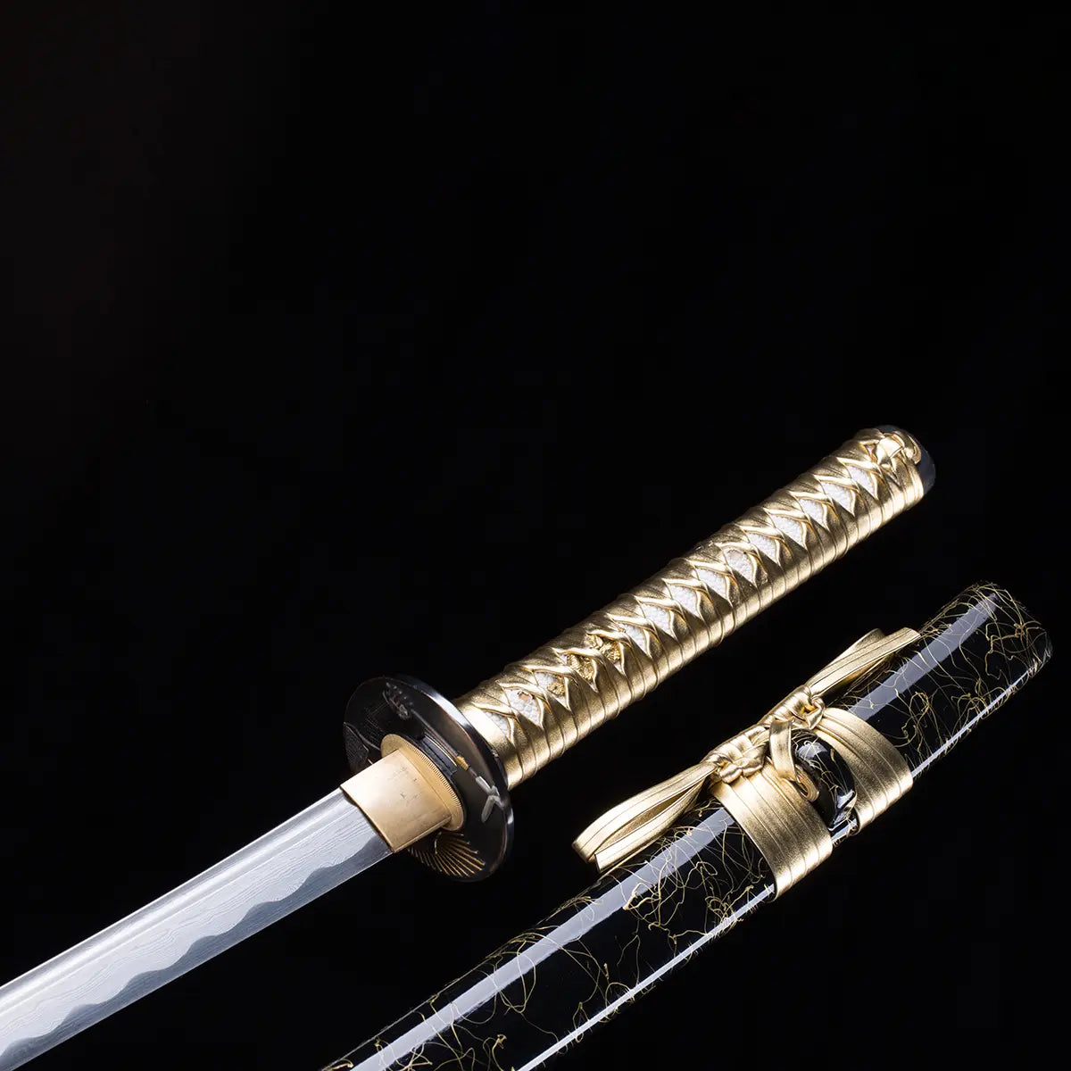 Le katana japonais Toyotomi Hideyoshi en finition or et noir, lame dégainée partiellement révélant le hamon ondulé. Saya noir laqué or et tsuka doré tressé, photographié sur fond noir studio Blade Bushido.