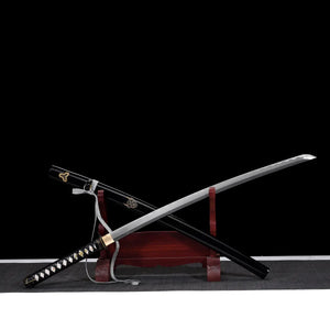Katana de Bill dans Kill Bill dégainé de son saya noir laqué orné, lame en acier carbone 1045 hamon ondulé, manche tsuka noir tressé avec samegawa blanc, présenté sur support en bois rouge, fond noir minimaliste.