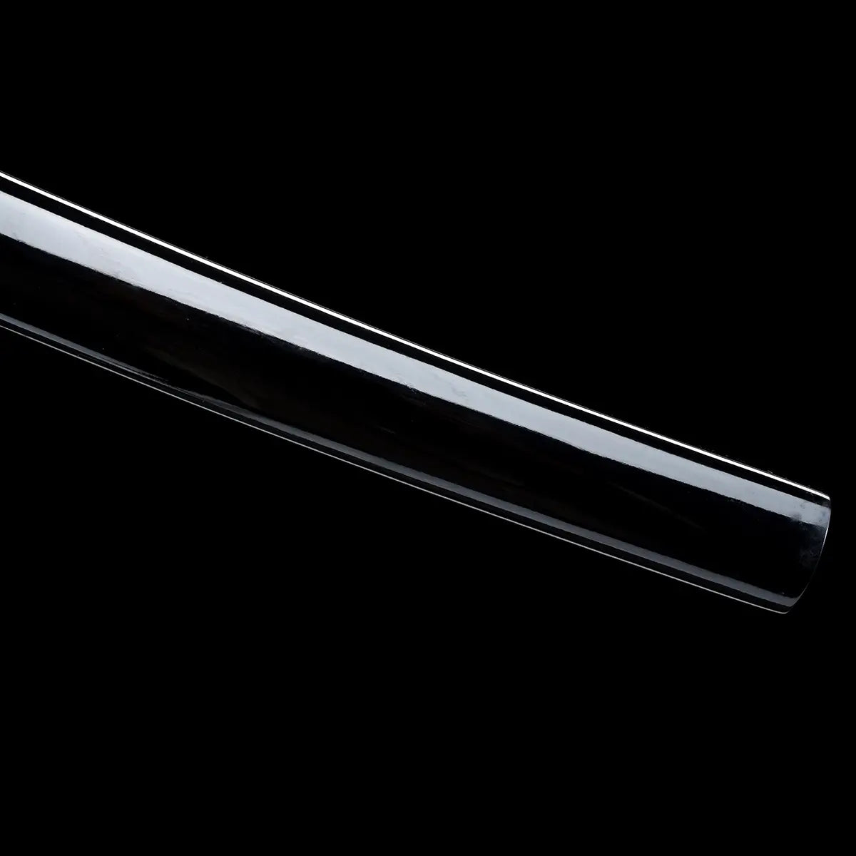 Close-up view of a Japanese katana blade against a deep black background, polished steel surface with a smooth reflective finish, visible straight cutting edge and subtle curvature, clean blade geometry without scabbard or mount, emphasis on the sharp edge line, steel texture, and precise traditional katana profile.
