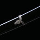 Détail du système d’attache (ashi) du fourreau du katana japonais artisanal Seiryū no Tachi photographié sur fond noir uni. Le saya noir laqué est visible avec une monture métallique décorative finement sculptée, fixée le long du fourreau pour le port traditionnel du tachi. Les éléments métalliques argentés présentent des motifs floraux en relief, avec des rivets visibles, soulignant la courbure et la finition soignée du fourreau.
