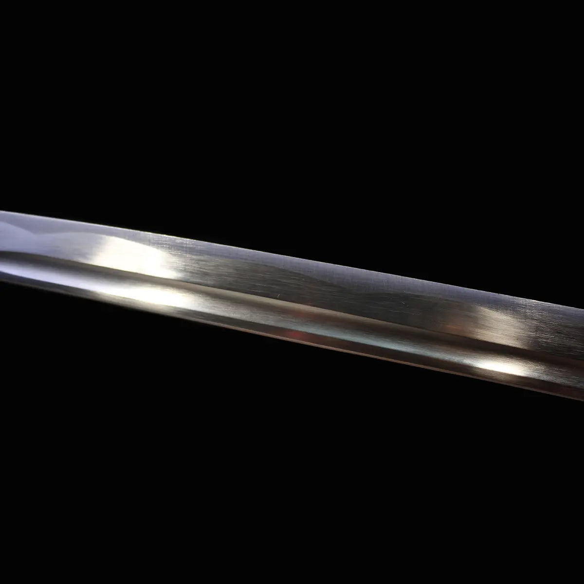 Gros plan de la lame en acier carbone 1045 poli avec rainure du katana japonais Shirasaya Ghost Dog