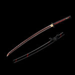 Katana japonais Ryū Honō présenté sur fond noir, lame damas rouge-feu sortie de son fourreau noir laqué à lignes rouges, poignée tsuka noire tressée de rouge et tsuba gravée d’un dragon. Photo studio Blade Bushido mettant en valeur la texture du damas et l’esthétique noire et écarlate du sabre.