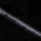 Close-up detail of Japanese katana Sakura no Ken blade, black background, black steel blade with fine engraved sakura floral pattern running along the blade surface, decorative engraving clearly visible, smooth polished finish highlighting the contrast of the floral motif
