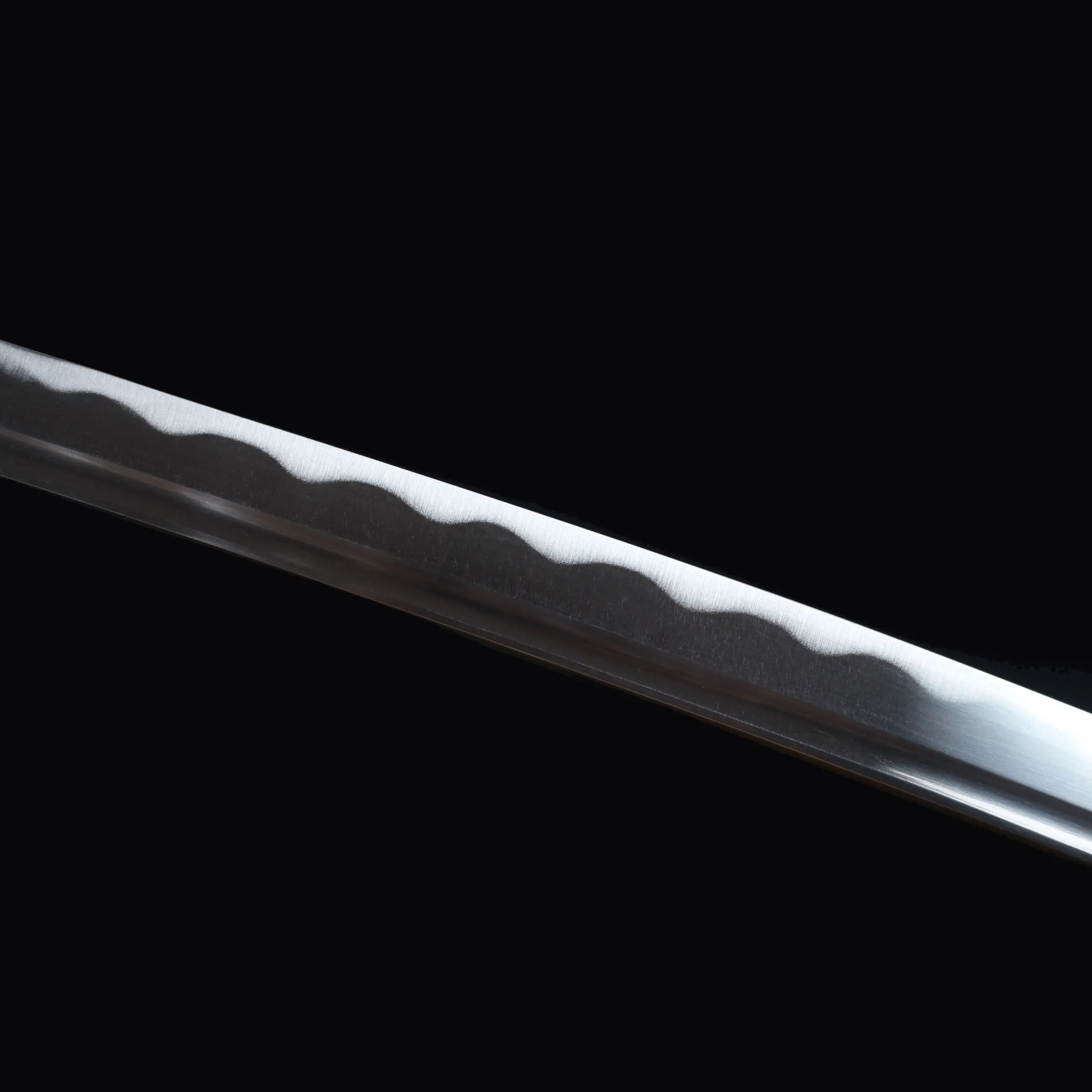 Gros plan sur le hamon poli du katana japonais Yubashiri, réplique en acier carbone 1045 de Roronoa Zoro One Piece.