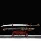 Sabre chinois Dao LONG WEI présenté hors de son fourreau noir texturé sur un support en bois rouge, avec lame courbe argentée, gorge centrale, poignée brune tressée, garde ronde en laiton et garnitures dorées à motifs dragon sur fond noir.