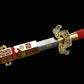 Épée chinoise Jian LONGQUAN HONG LONG partiellement sortie de son fourreau rouge texturé, avec lame droite en acier plié, inscription dorée visible, garde dorée ouvragée et garnitures en laiton sur fond noir.
