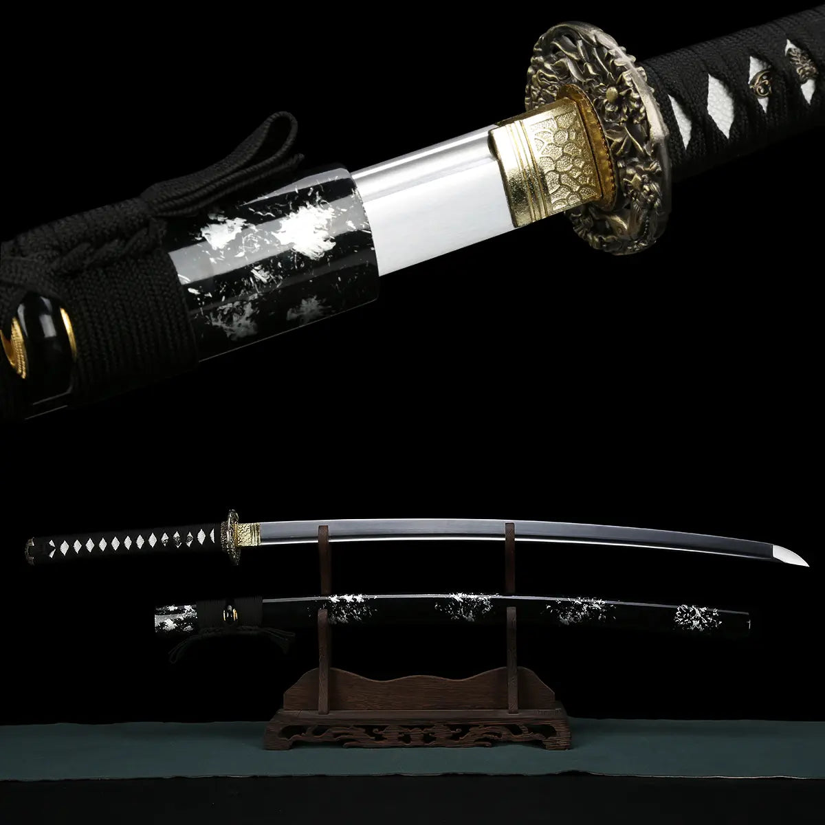 Composite image of the Japanese handmade katana Renge no Ken on a deep black background, upper view showing close-up of gold-toned habaki with geometric pattern and dark metal lotus-pattern tsuba, lower view showing the katana fully unsheathed on a carved wooden stand, polished carbon steel blade with bohi groove, sharp kissaki, black tsuka wrapped with black cord over white ray skin, black glossy saya with white lacquer splash patterns positioned below the blade
