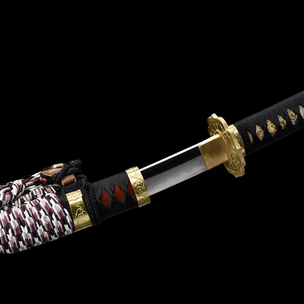 Close-up detail of the Japanese tachi katana Taiyo Taisho photographed on a deep black background, focusing on the handle and upper scabbard junction with a braided sageo cord wrapped around the dark red lacquered wooden saya, black tsuka wrapped in black ito over white ray skin panels, gold-colored fittings including fuchi and habaki visible, studio lighting highlighting the cord texture, lacquer finish, and traditional Japanese mounting details
