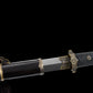 Gros plan sur une épée chinoise Jian YI XIN partiellement sortie de son fourreau noir laqué, avec lame droite en acier Damas moderne multicouche, garde en laiton vieilli décorée et poignée noire texturée en galuchat. Fond noir mettant en valeur les finitions traditionnelles de ce Jian chinois artisanal de collection, Tai Chi et Wushu.